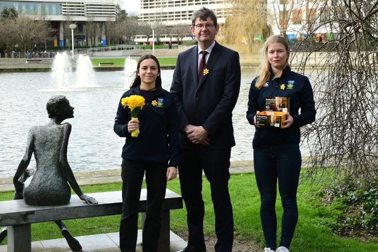 Alaïs Diebold (UCD Women's Rugby), Acting UCD President Professor Mark Rogers, Lola Cavaller (UCD Women's Rugby) standing over looking the main lake.